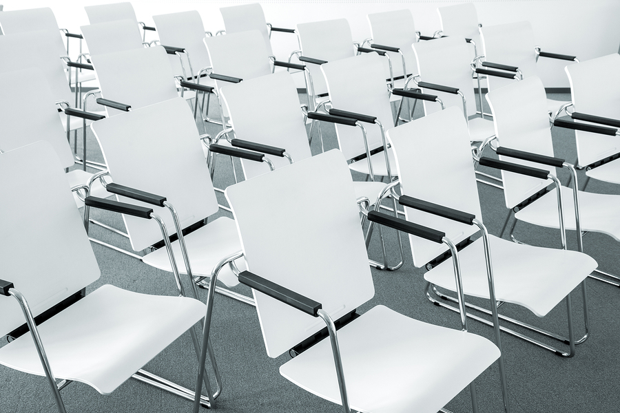 photo of white modern white chairs in rows at an angle